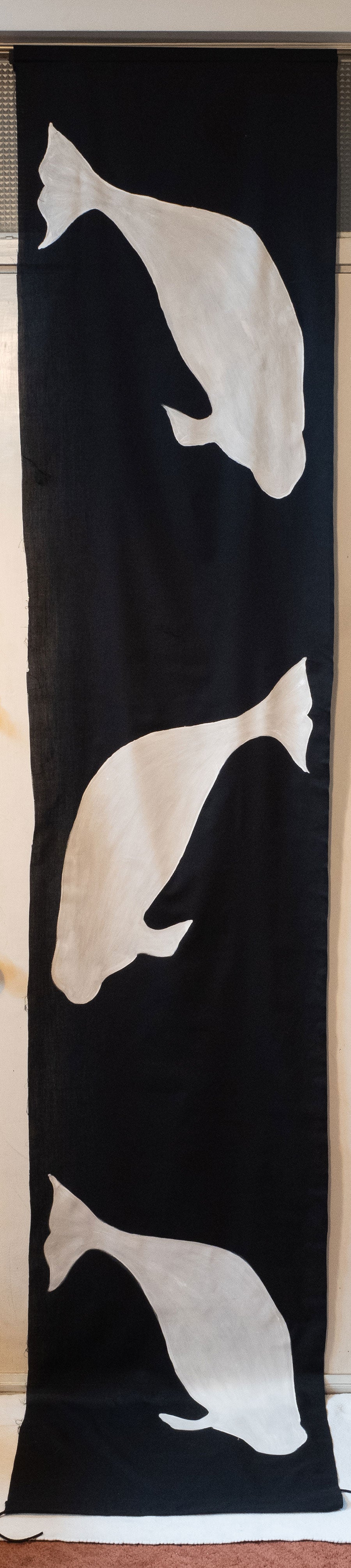 Beluga whales in black and white on a tall banner.